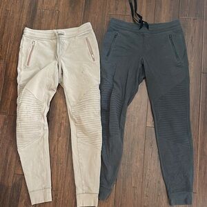 Two Beige and Black ALO Moto Joggers